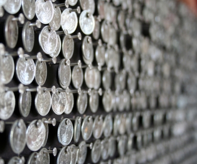 AMARAT DETAIL – 2010 – MGFD CAYMAN AMARAT – 2010 – MGFD CAYMAN Guatemalan coins and stainless steel nails on stained veneer panel - 67” x 67”